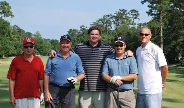 Chris Robertson of TES with former New Orleans Saints player Jon Stinchcomb at the 2011 Children’s Hospital Golf Tournament.